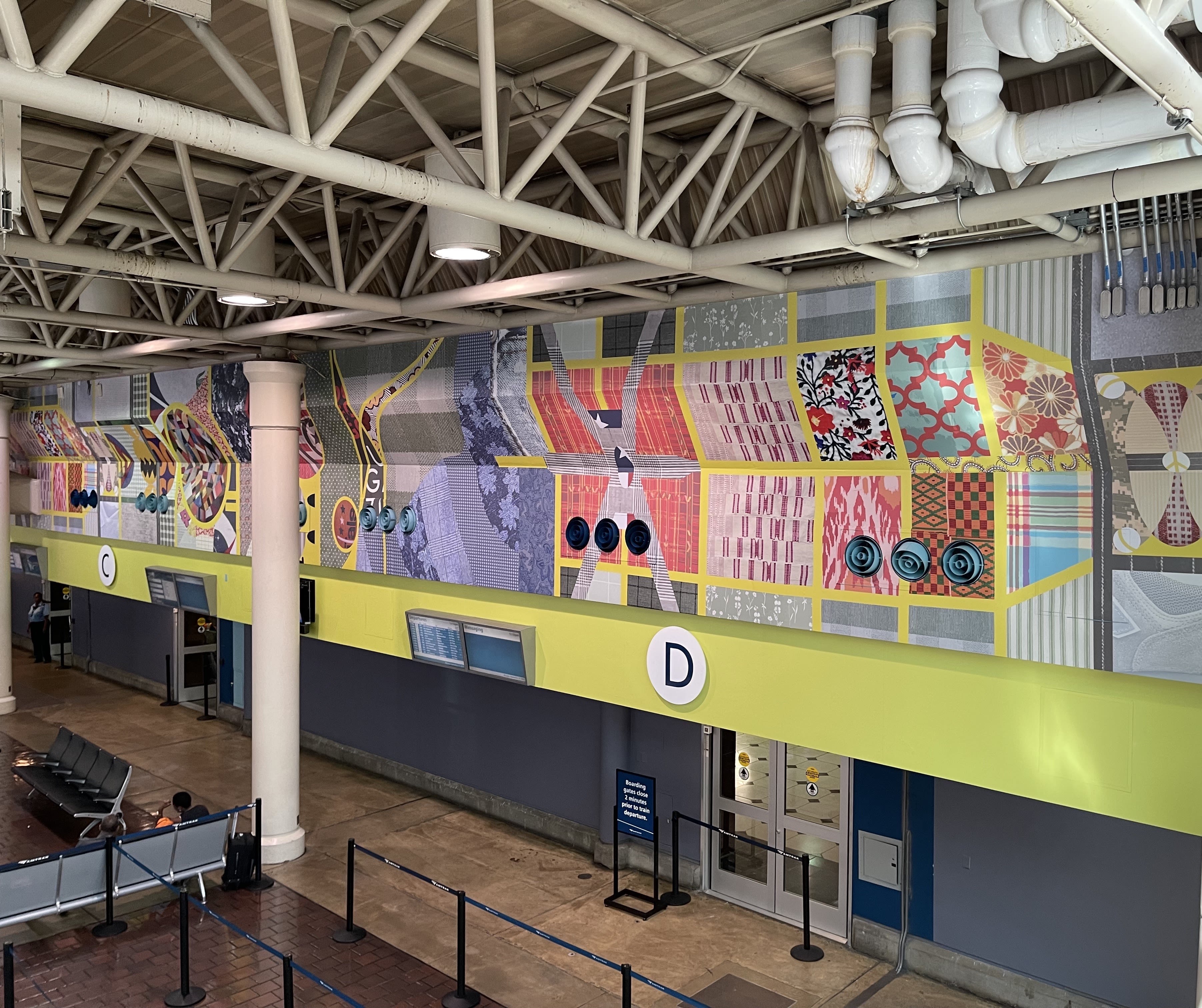 A public walkway with bright, geometric art.