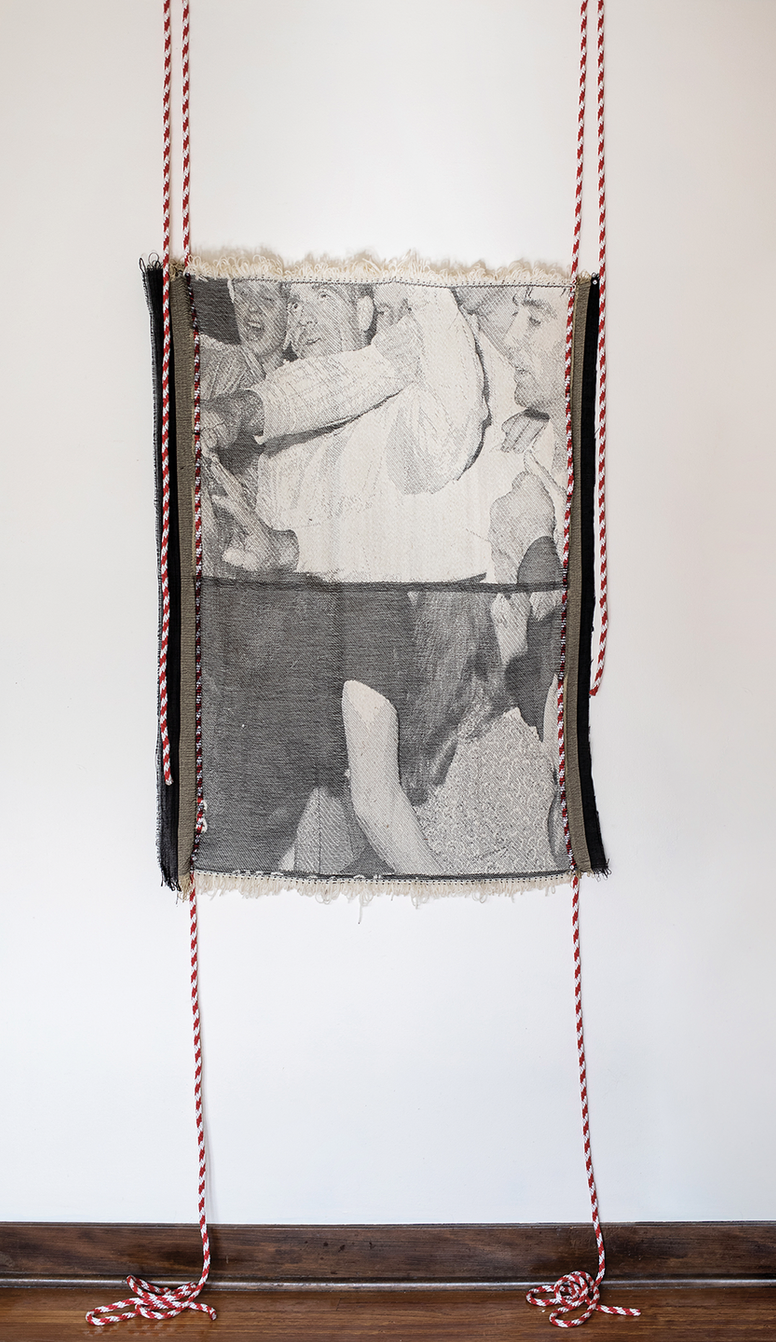 Photos printed on cloth, suspended with red thread