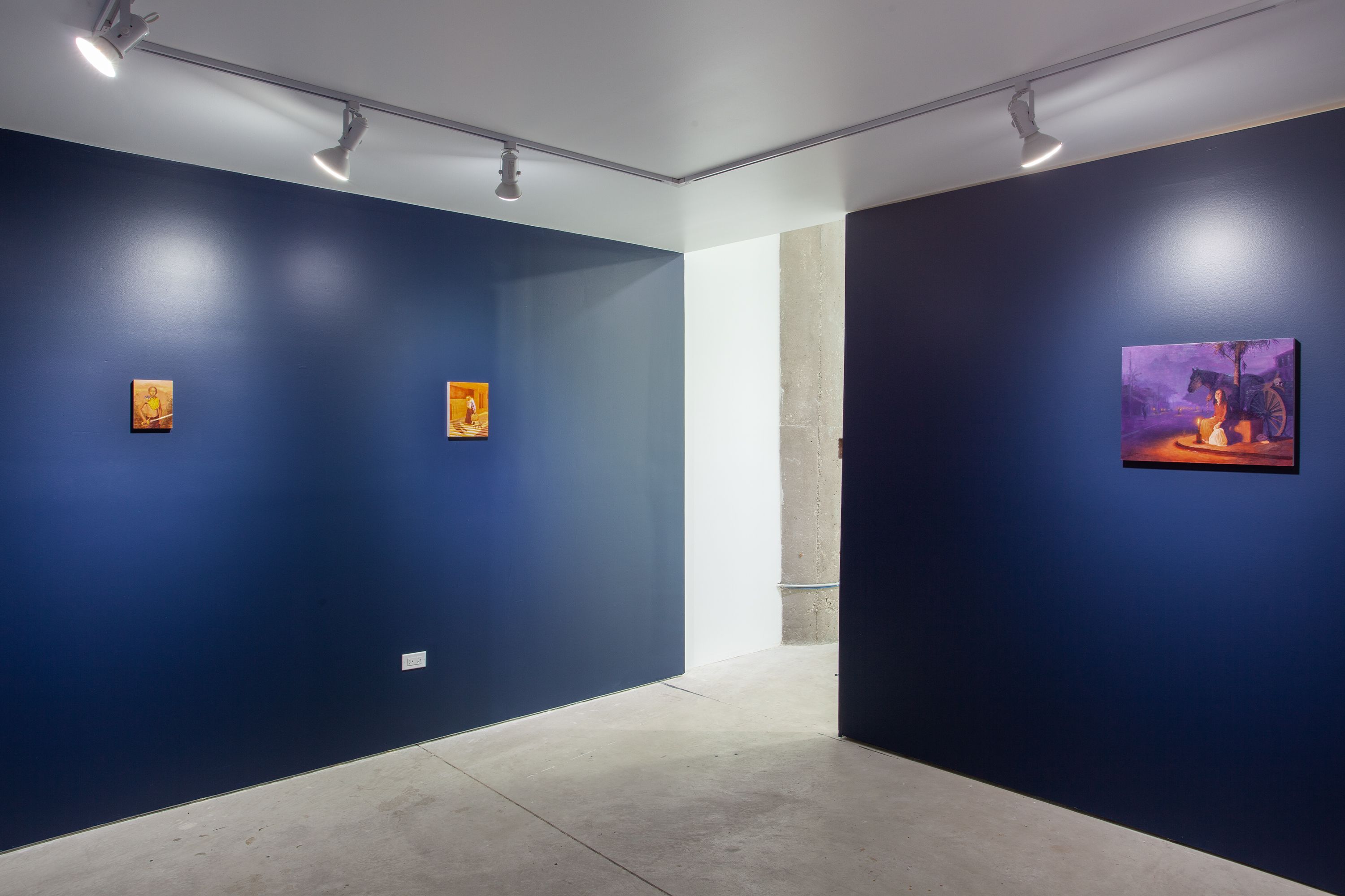 A gallery space with blue walls