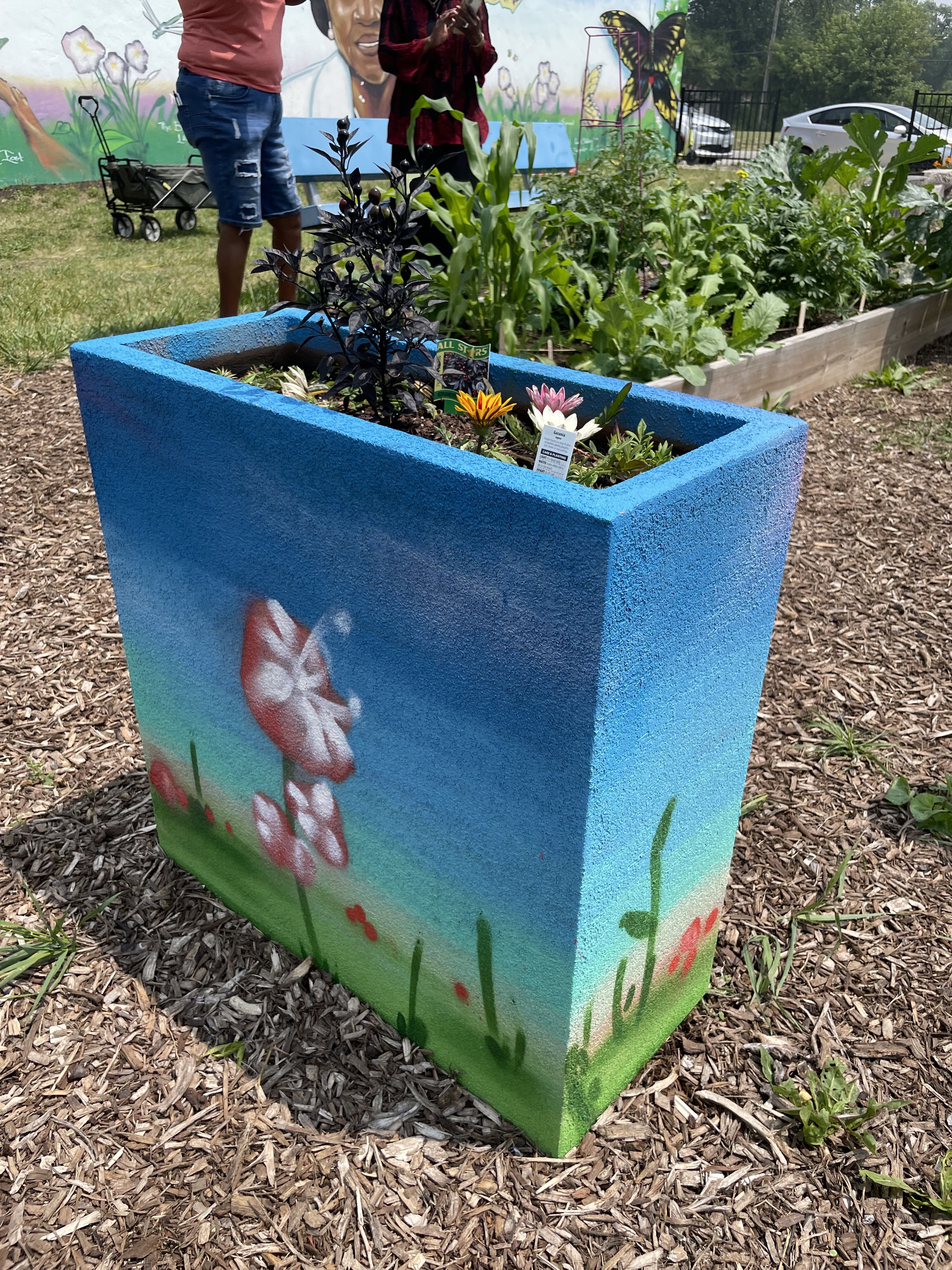 A painted planter in a garden