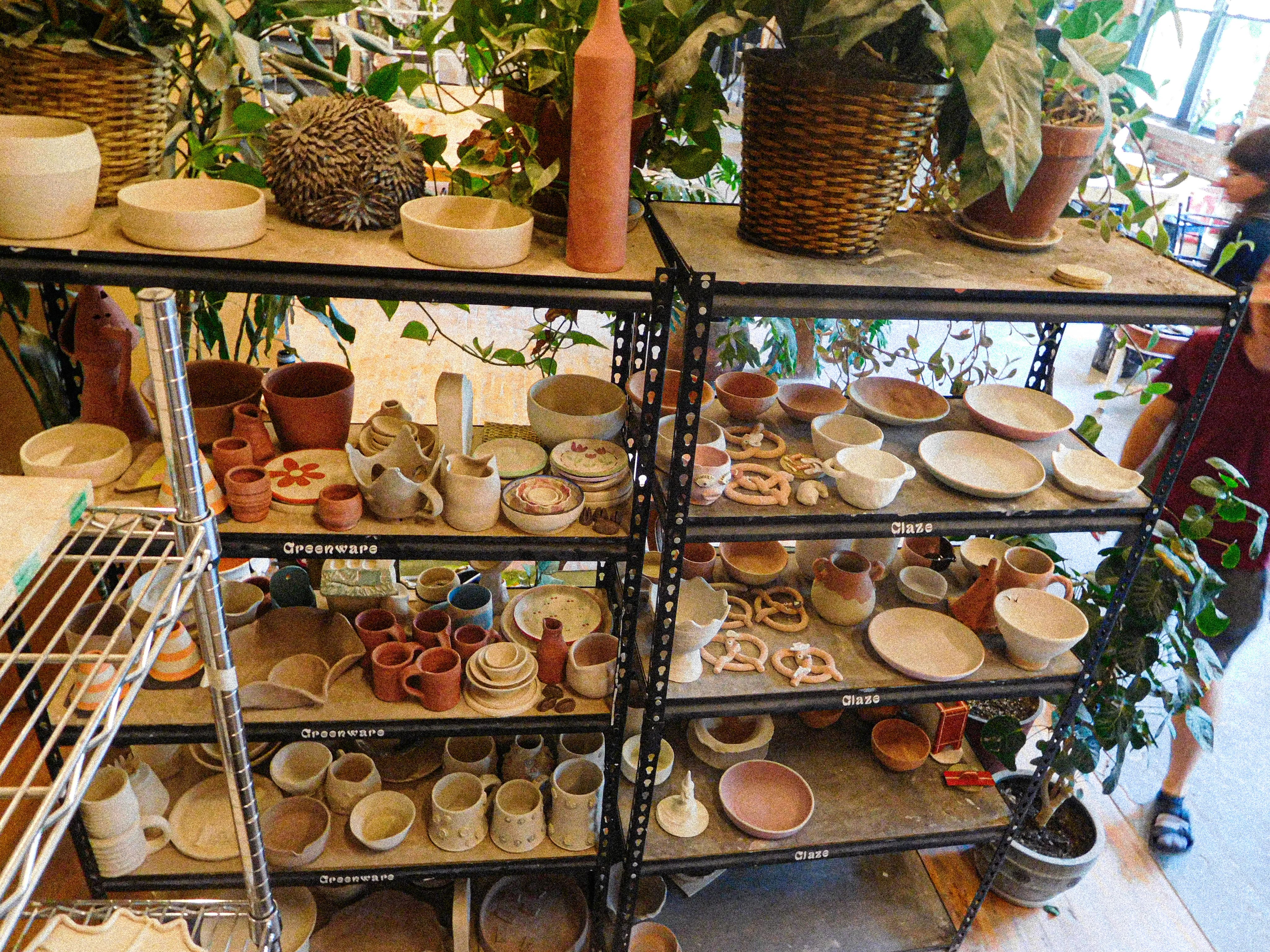 Metal shelves of ceramic works in progress