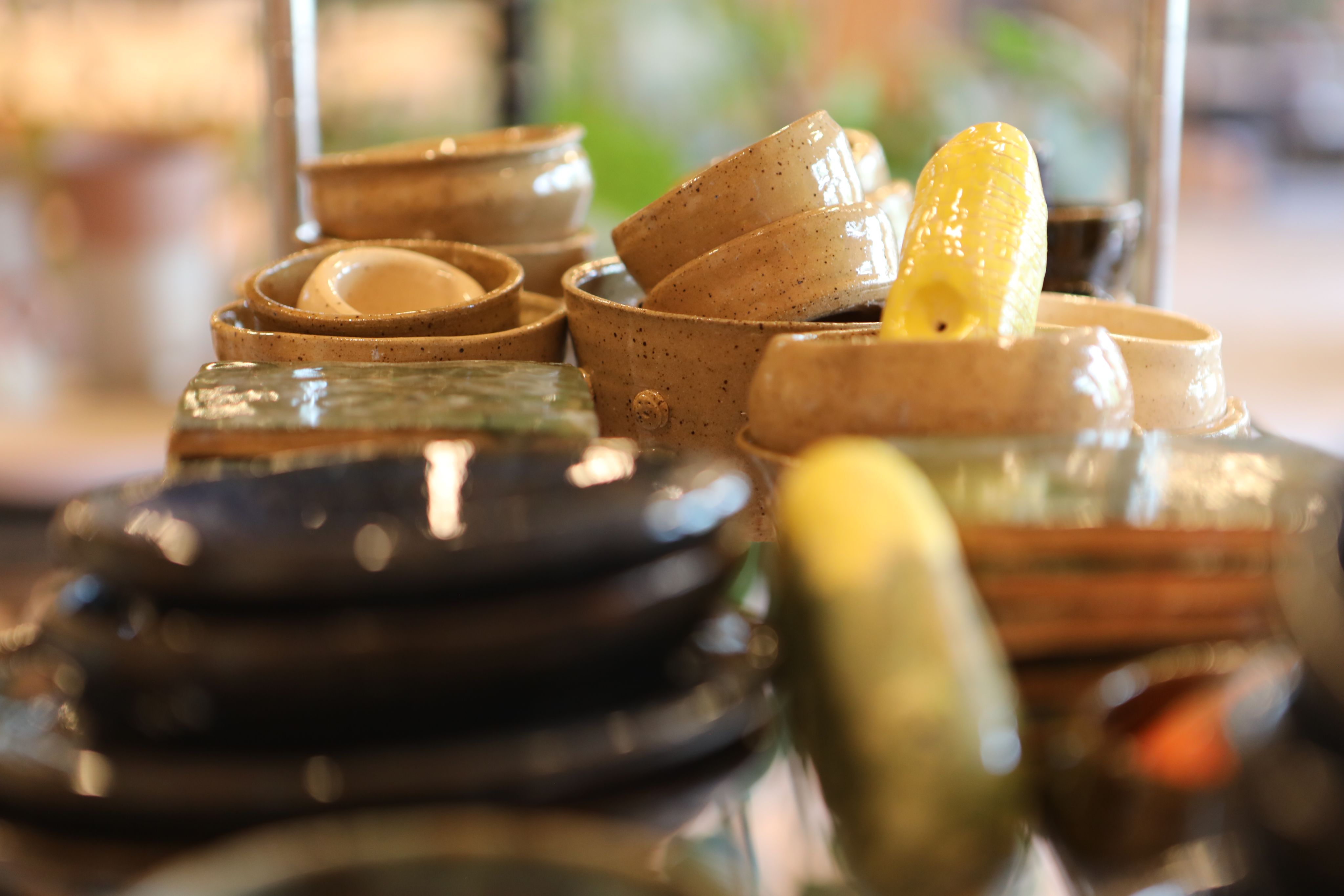 A close-up of ceramic pots and cups