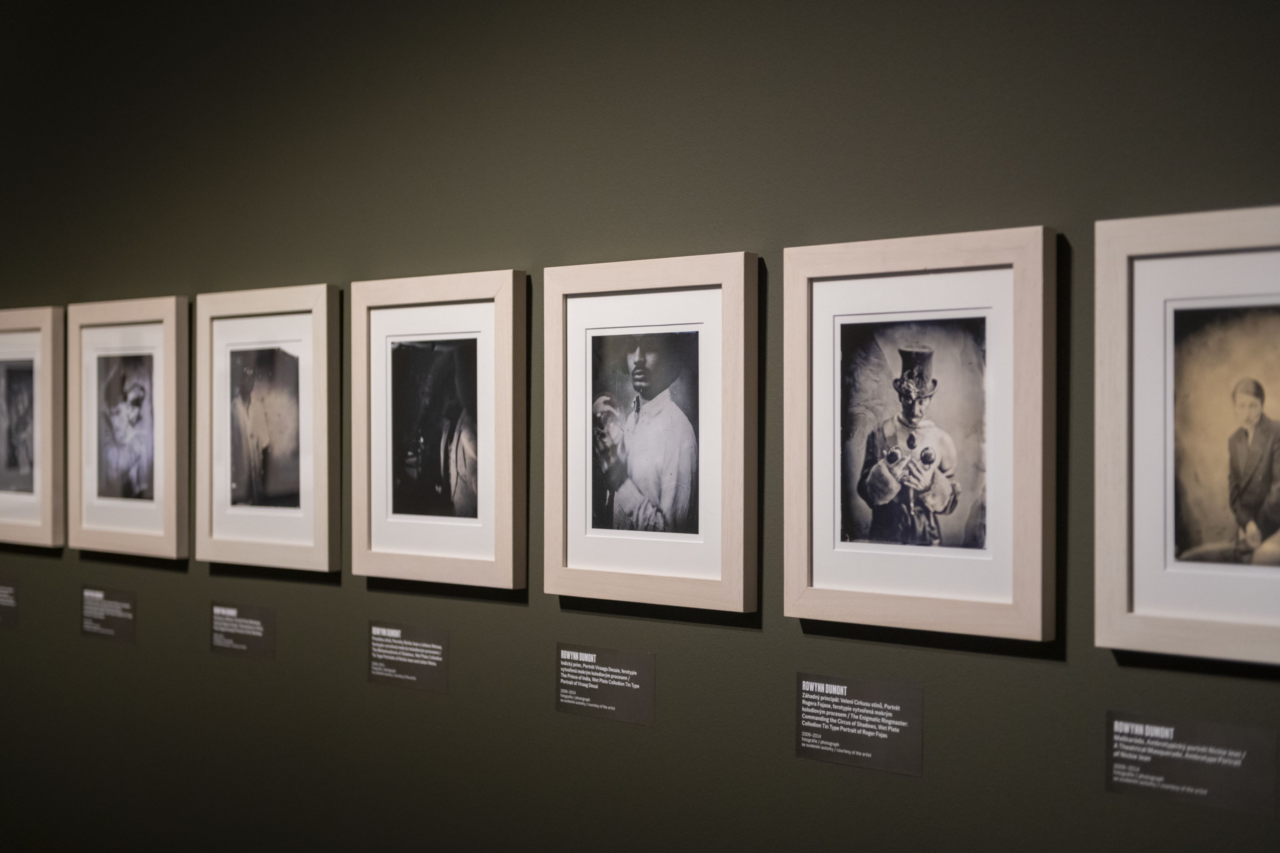 Photographs line the walls of a gallery