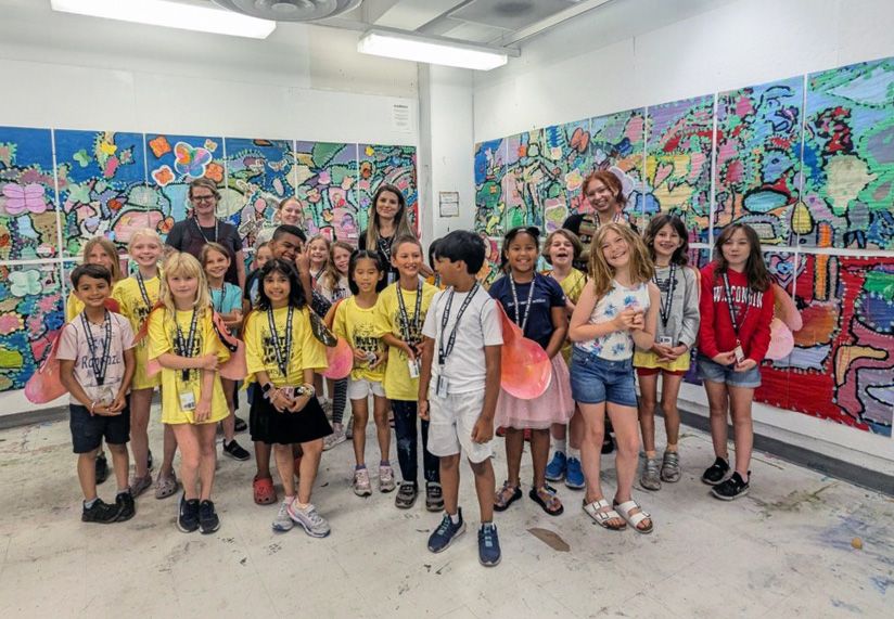 The group of students standing in front of the finished mural