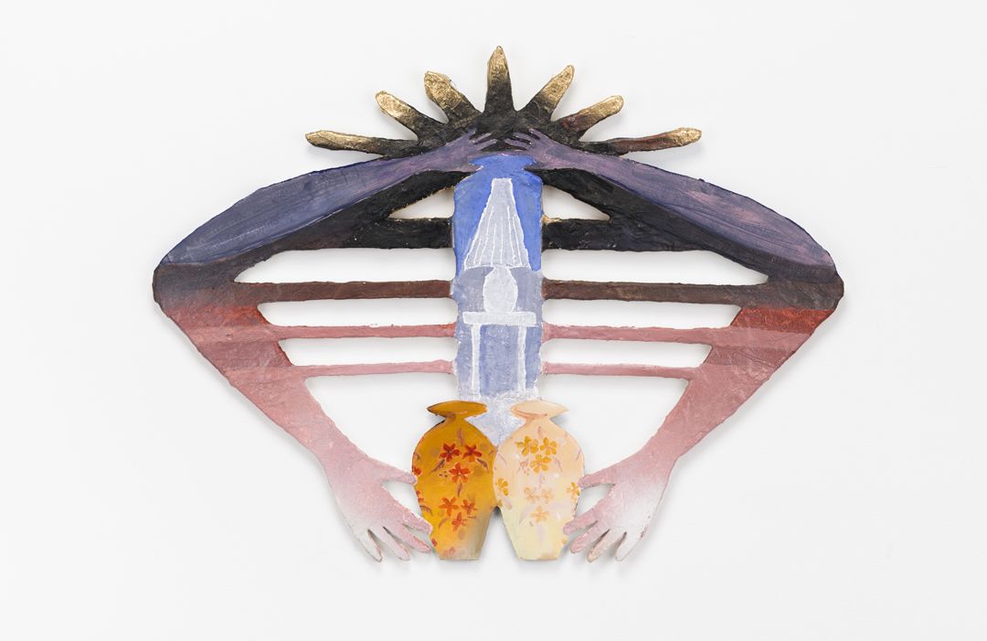 A flat metal sculpture of two hands holding vases pinned to a white wall