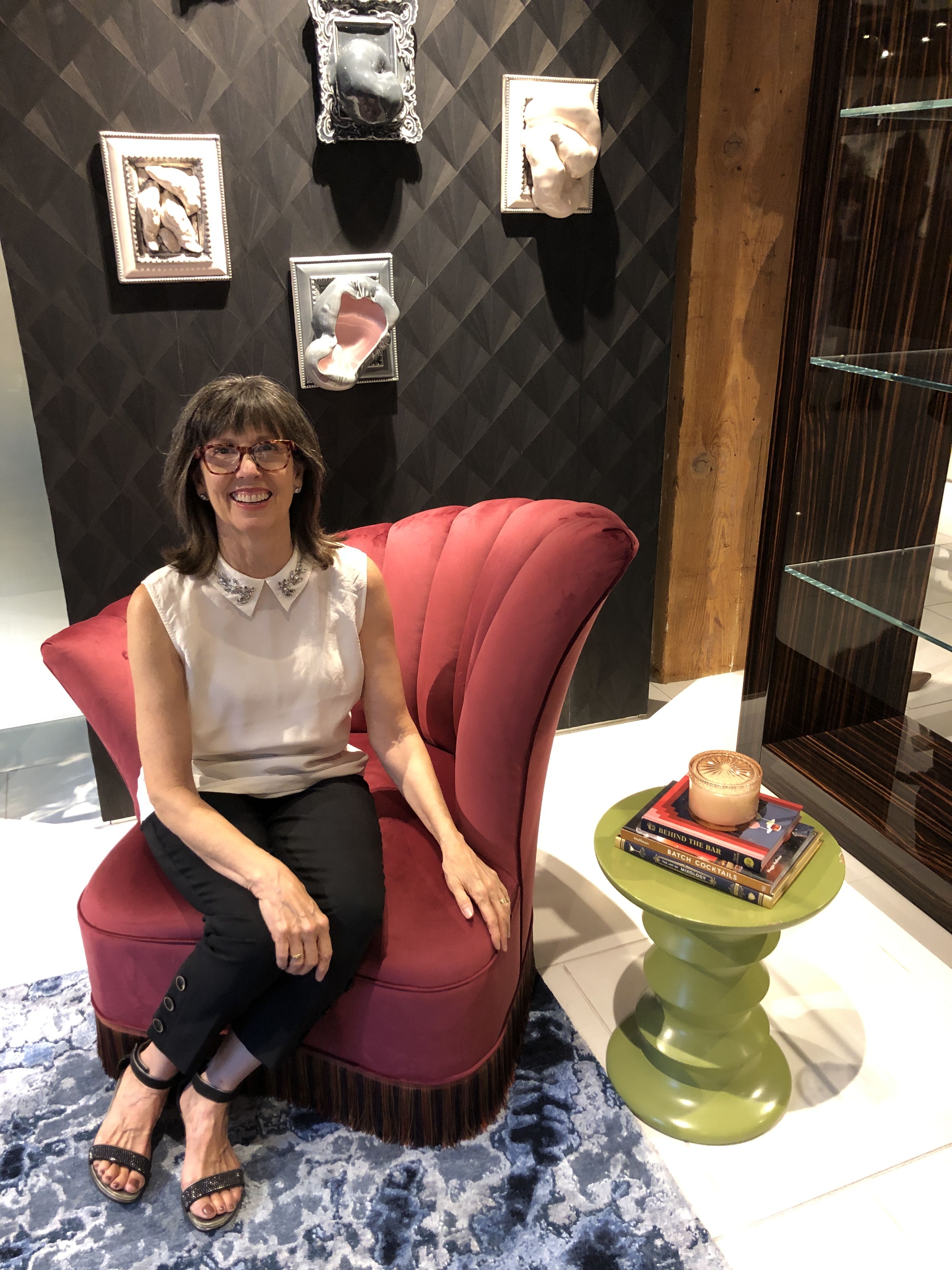 A woman sits in a modern sculptural chair
