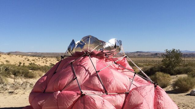 A large inflated pink bag with metal scaffolding