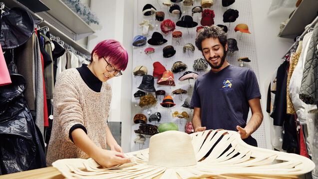 Two people working in the Fashion Resource Center. 