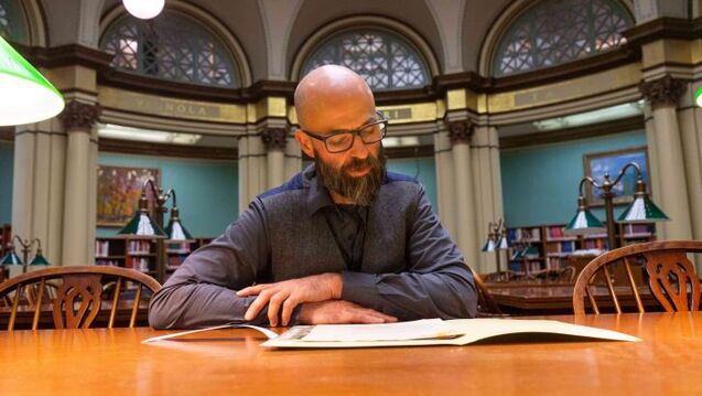 Image of Professor Nicholas Lowe in a library