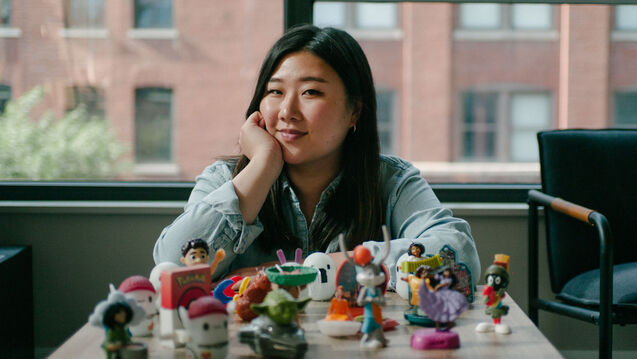 Eileen poses in front of some McDonald's Happy Meal toys they designed