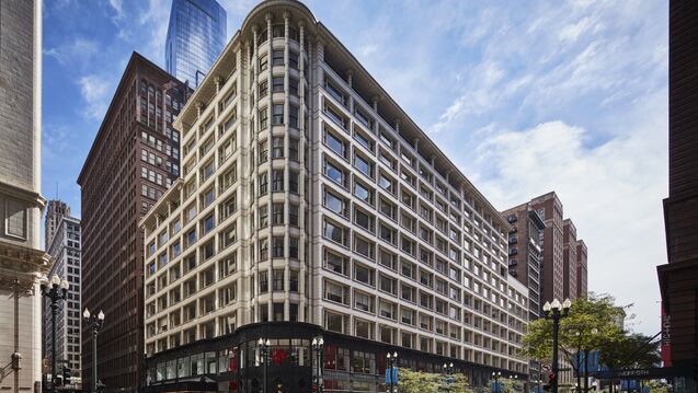 A large V-shaped building on a corner in Chicago.