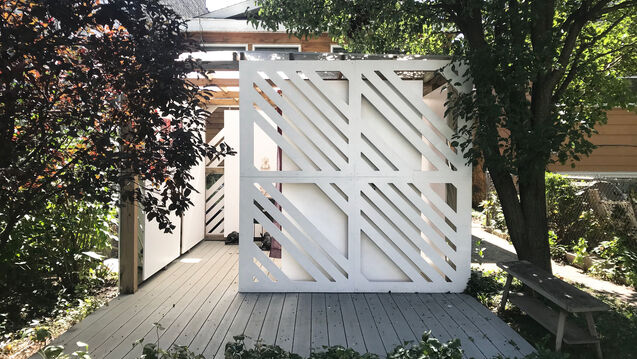 Outdoor space featuring trees, and a white structure.