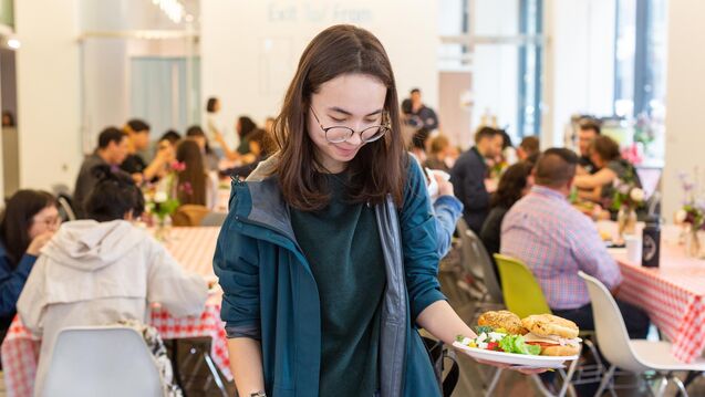 A student adding food to their plate at the neiman center