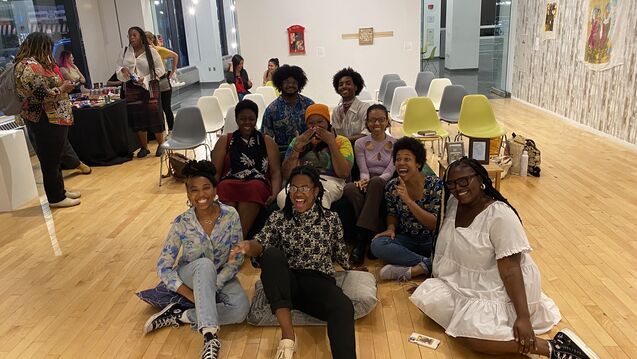 Group photo of COBRA members sitting together in SITE gallery space for exhibition program