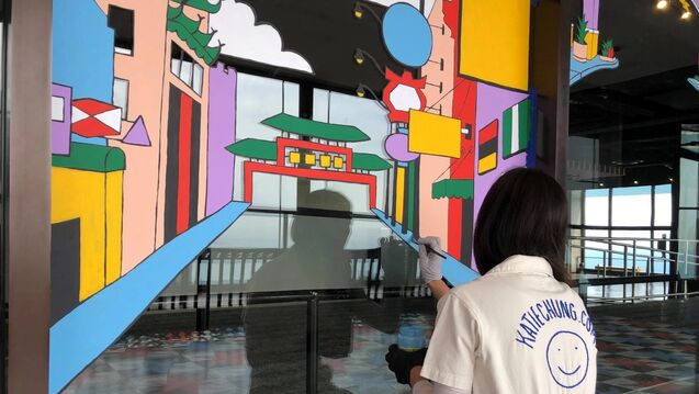 Katie Chung painting mural on Observation Deck