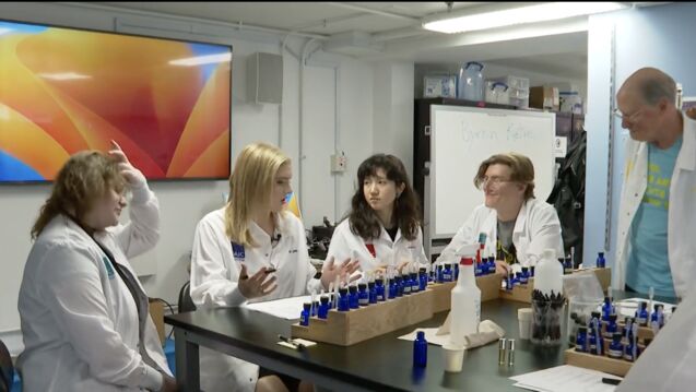 SAIC students experimenting with scents to create unique artworks in a classroom setting.