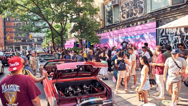 Pop-up event in Los Angeles with a red low-rider car and a crowd around it