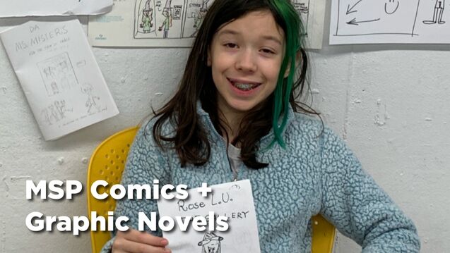 A middle schooler with a fair skin tone and shoulder-length brown and green hair holds up their own comic. 