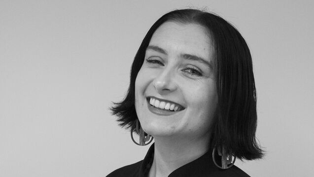 Black and white portrait of Tatyanna Scott, an adult person with a fair skin tone and short dark hair. 