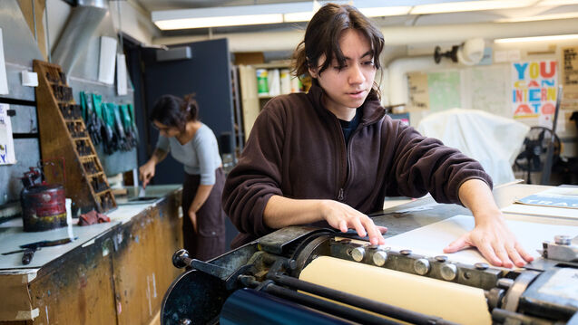 A student working in the Visual Communication Design letterpress studio.