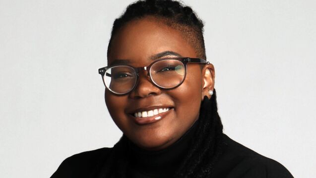 Headshot of Myia Brown, an adult Black person with glasses and locs. 