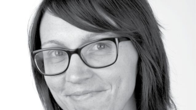 Black and white headshot of Rebekah Champ, an adult with a fair skin tone, short dark hair, and glasses. 