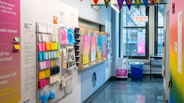 A wall inside the Service Bureau with colorful paper samples hanging up.