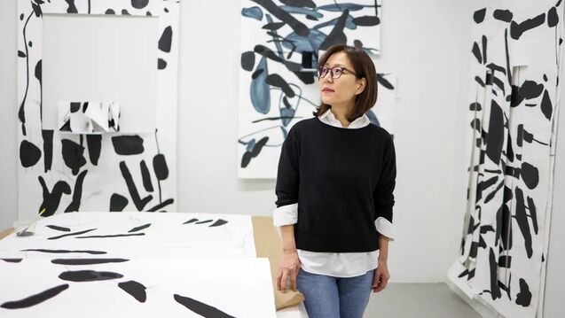 Yoonshin Park surrounded by her art 