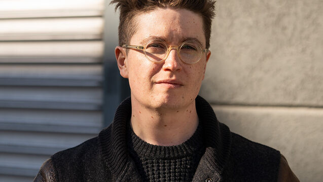 A portrait of a man in glasses and a leather coat