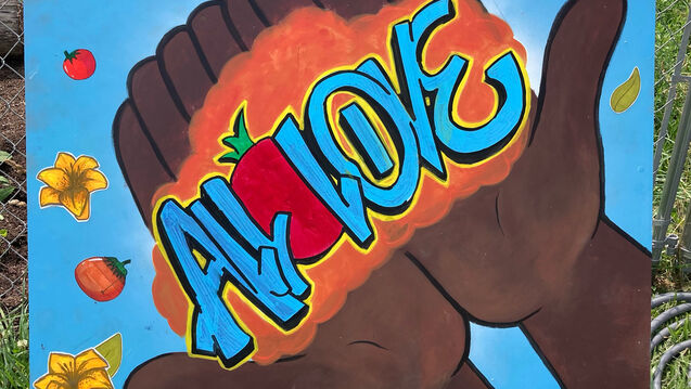 A street art style ainting of two hands holding the words ALL LOVE 