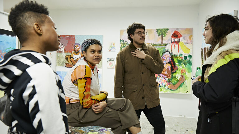 Multiple students at the Advanced Painting and Drawing open studio night. 