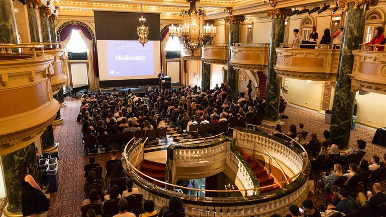 An image of a large group of people sitting in the School of the Art Institute of Chicago's Ballroom located in the MacLean Center.