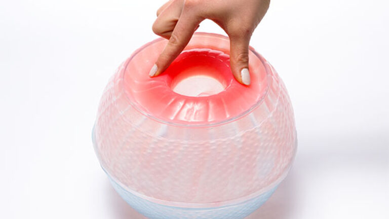  Image of a hand touching a spherical glass object.