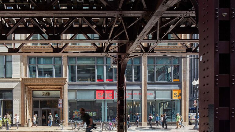 Exterior image of students entering and leaving SAIC’s Sharp Building.