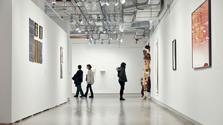 An image of students in a large, open gallery space.