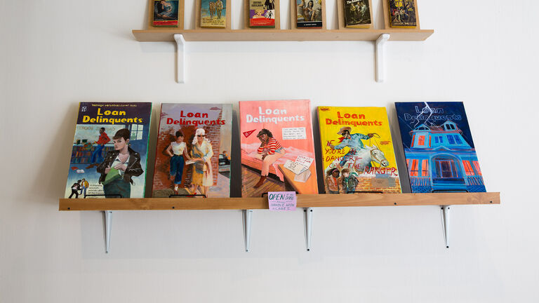 Two shelves of hand-painted books. 