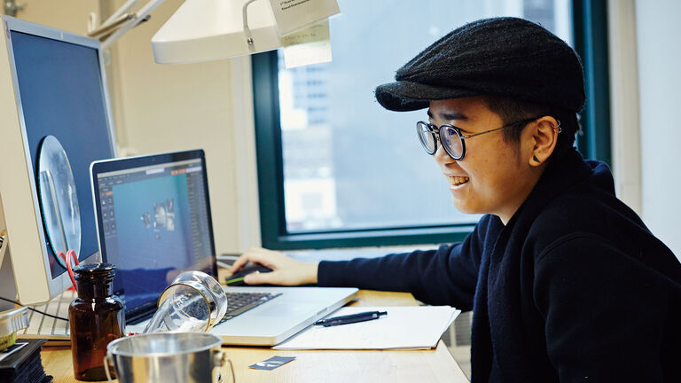 A person sitting at a desk working on their computer. 