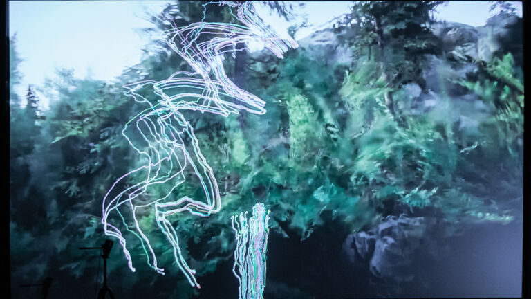 A video still of abstract green and grey shapes. 