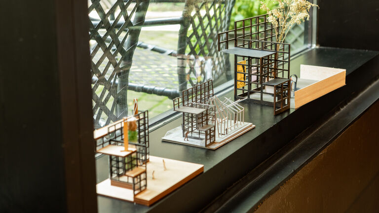An image of a few small, wooden models on a windowsill.