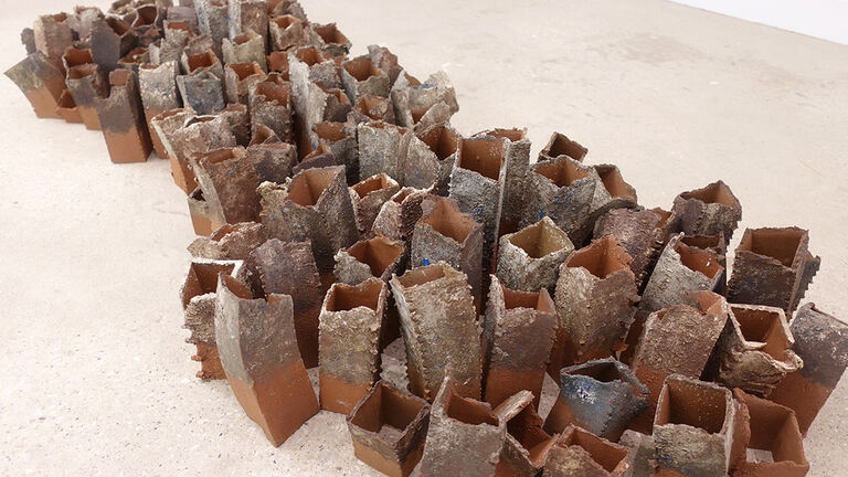 Ceramics sculpture laid across the ground