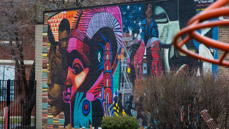 An elaborate, colorful piece of street art situated on a wall