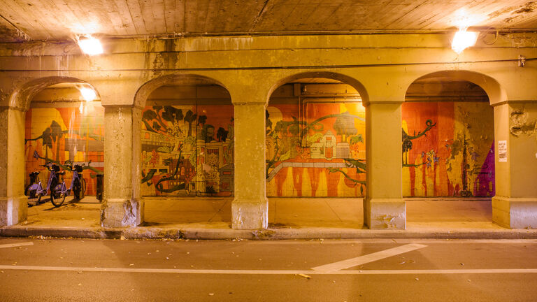 An elaborate painting of buildings sits in an underpass