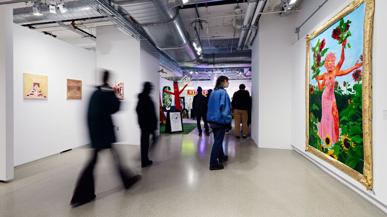 People observe paintings and pieces in the SAIC Galleries