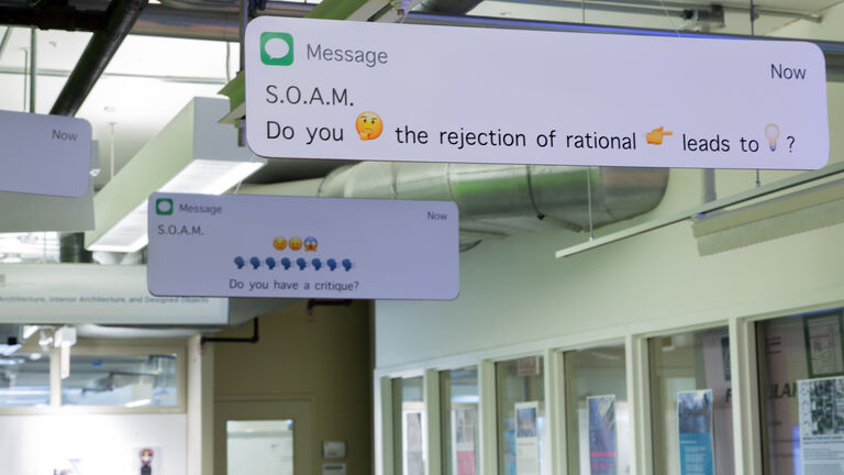 Apple imessages displayed as large signs in an SAIC hallway