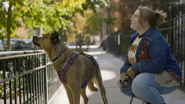 Marley kneeling next to her dog