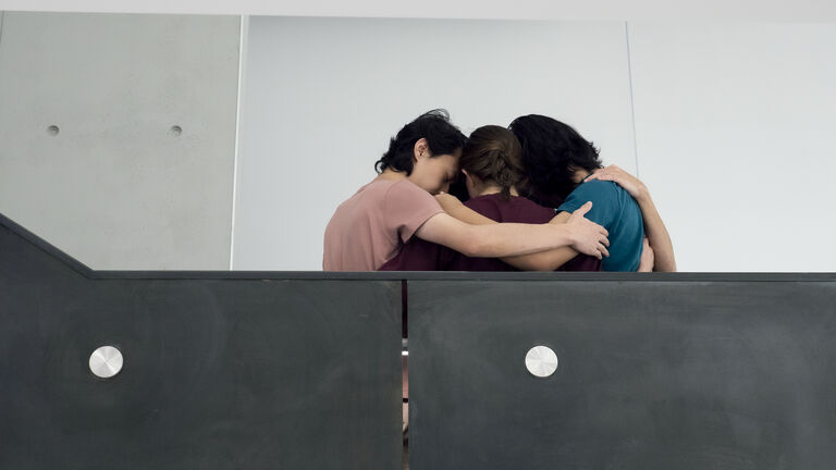 A group hug on a balcony