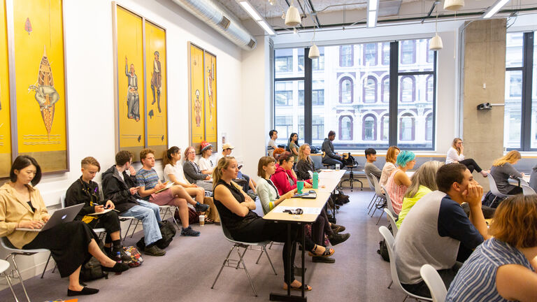 A group of students in a classroom. 