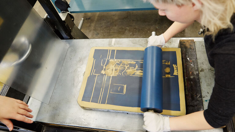 A student works on a print piece