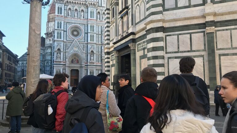 A large group of students standing outside the Piazza del Duomo in Florence, Italy.