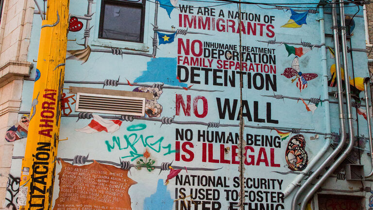 A piece of street art declaring “we are a nation of immigrants” amongst other pro-immigration sentiments